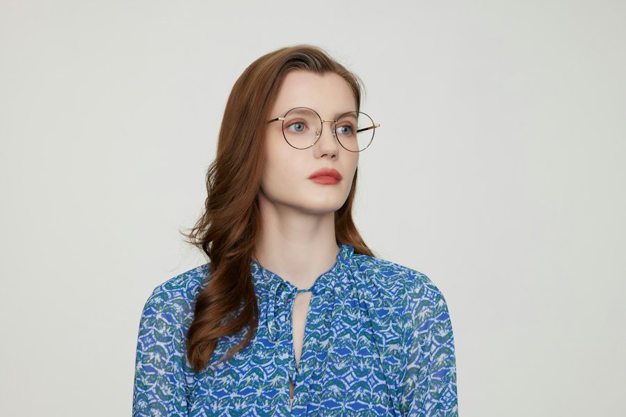 Woman wearing gold round glasses