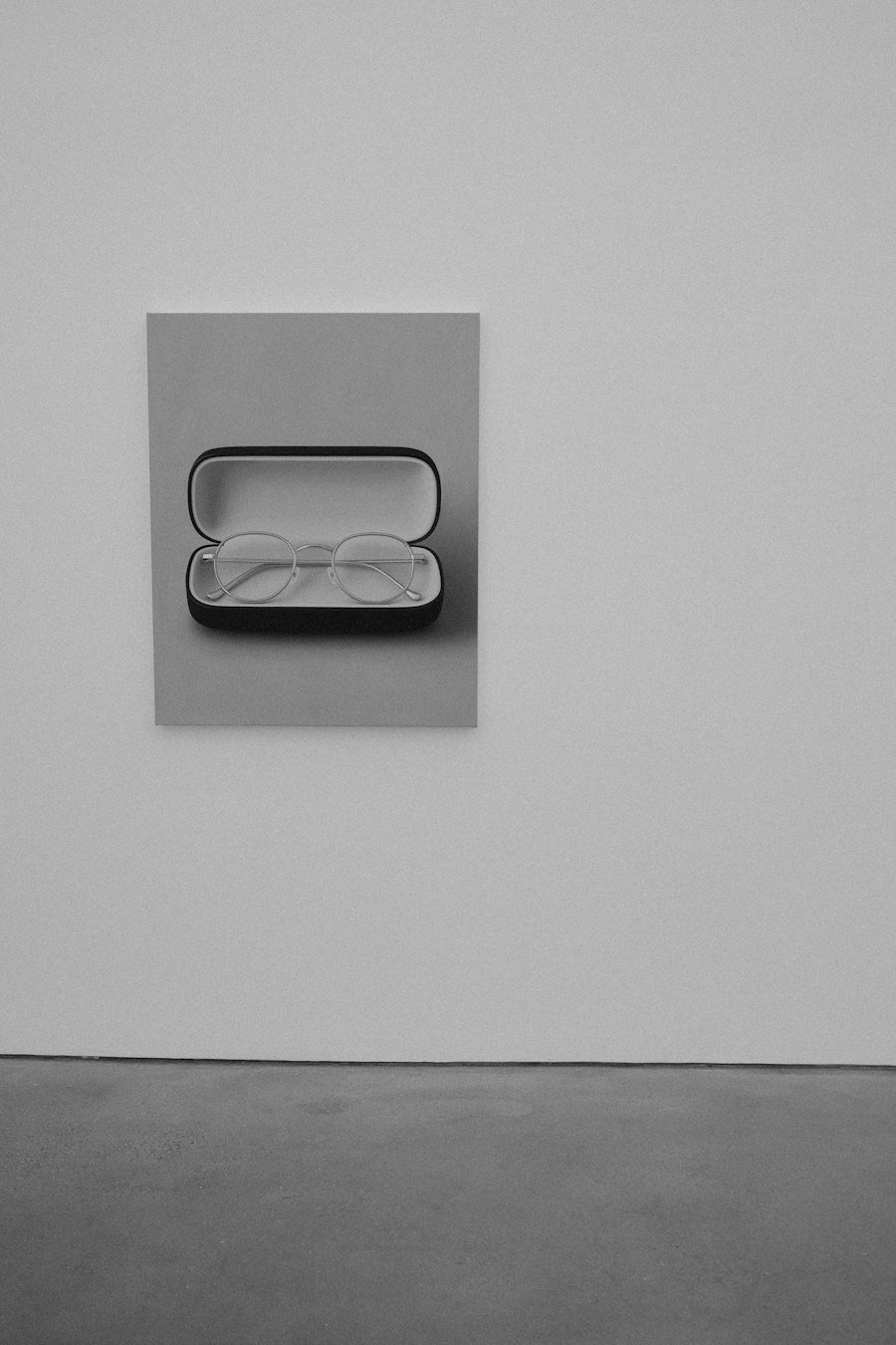 Eyeglasses resting in a grey case